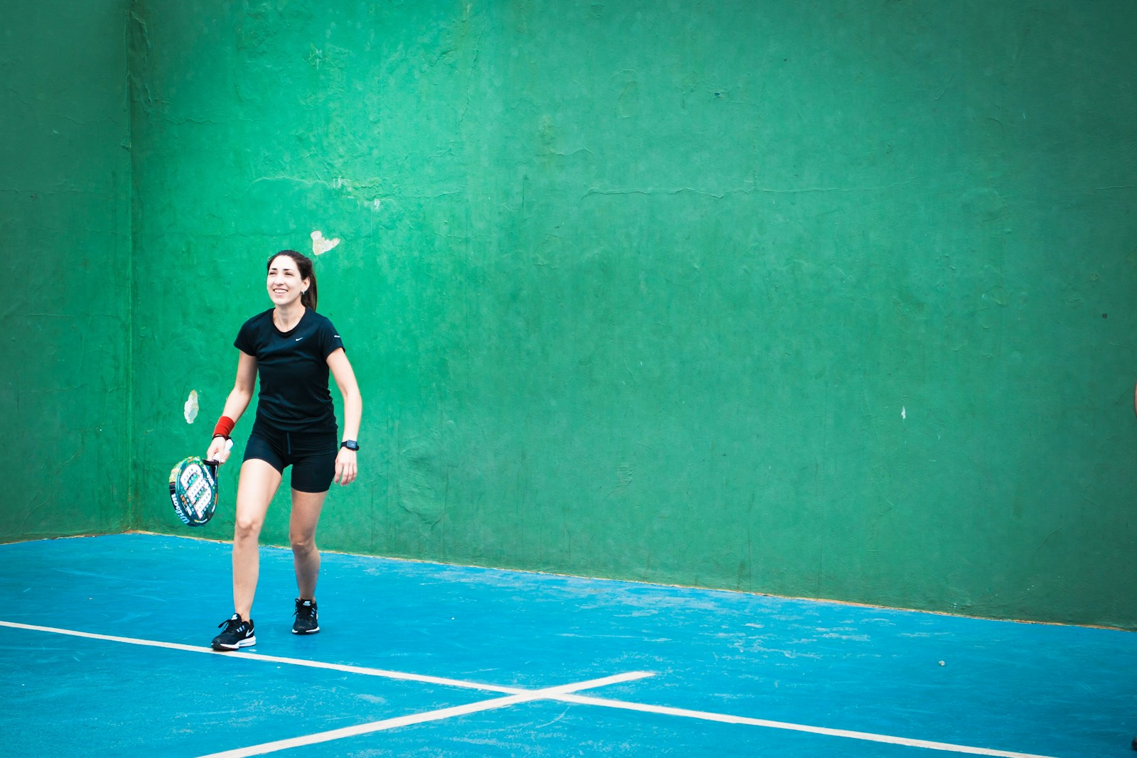 a woman standing on a tennis court holding a racquet