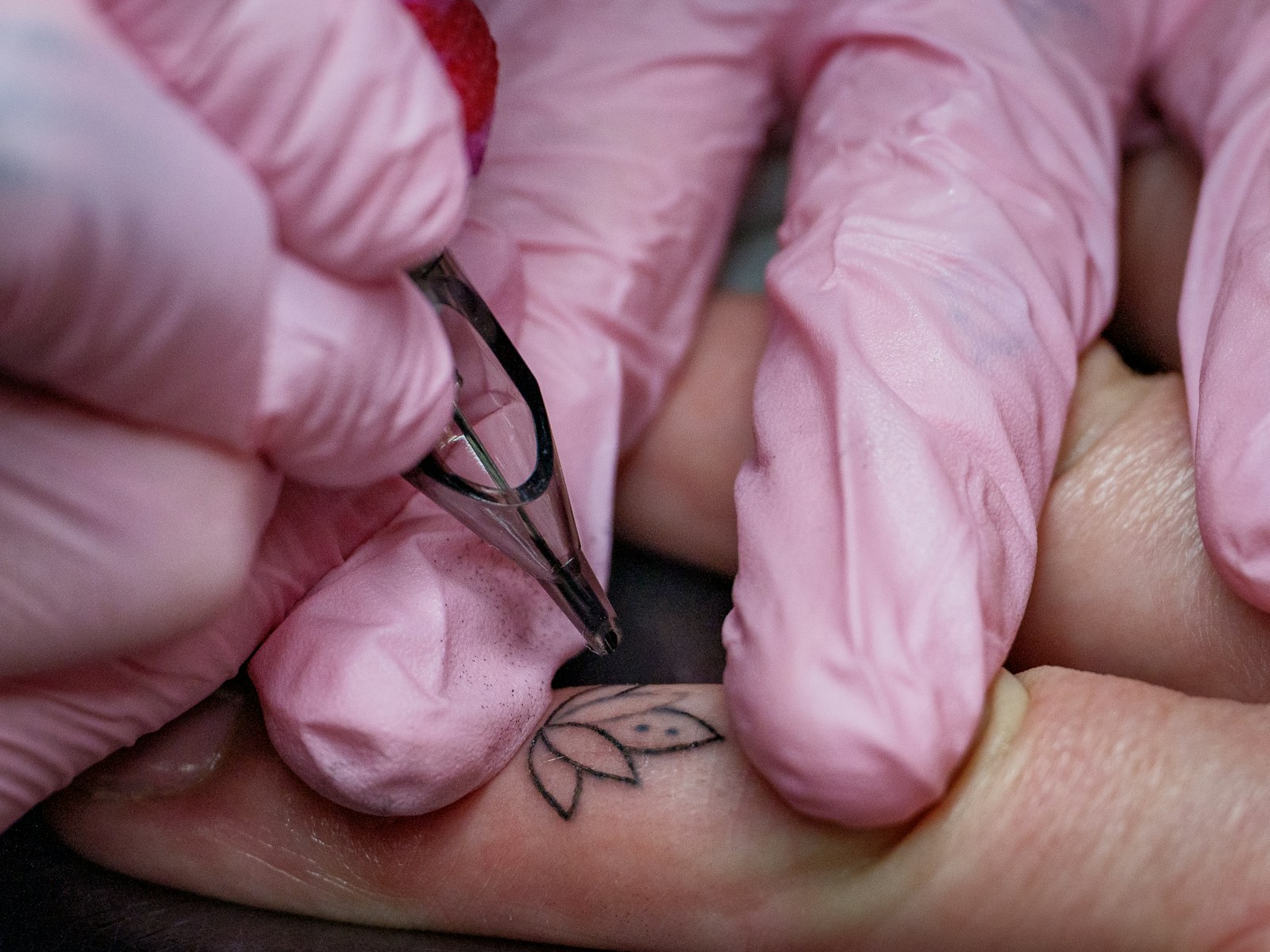 A close up of a person's hand with a tattoo on it